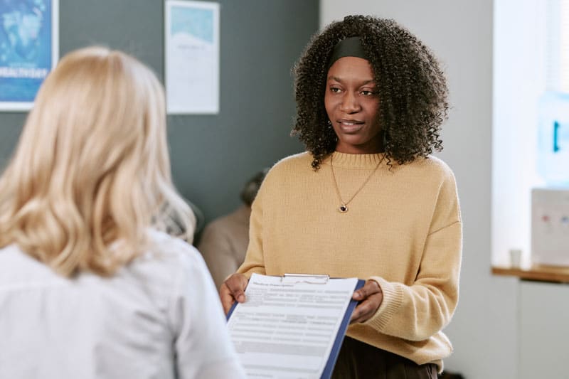 Woman returning Hygiene, Safety & Regulations consent form | ESI Show